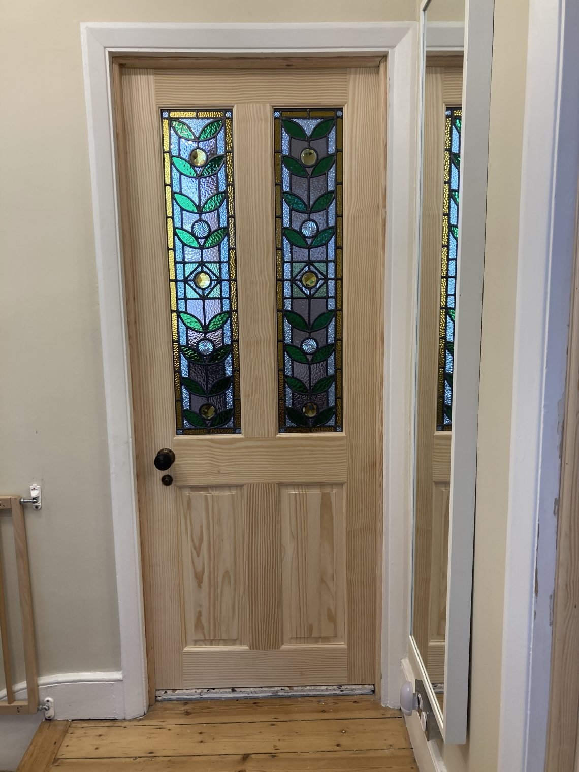 After a great deal of finessing this new pine door from trade was fitted, with its new handles and latches. The glass was added after hanging by a glazier.