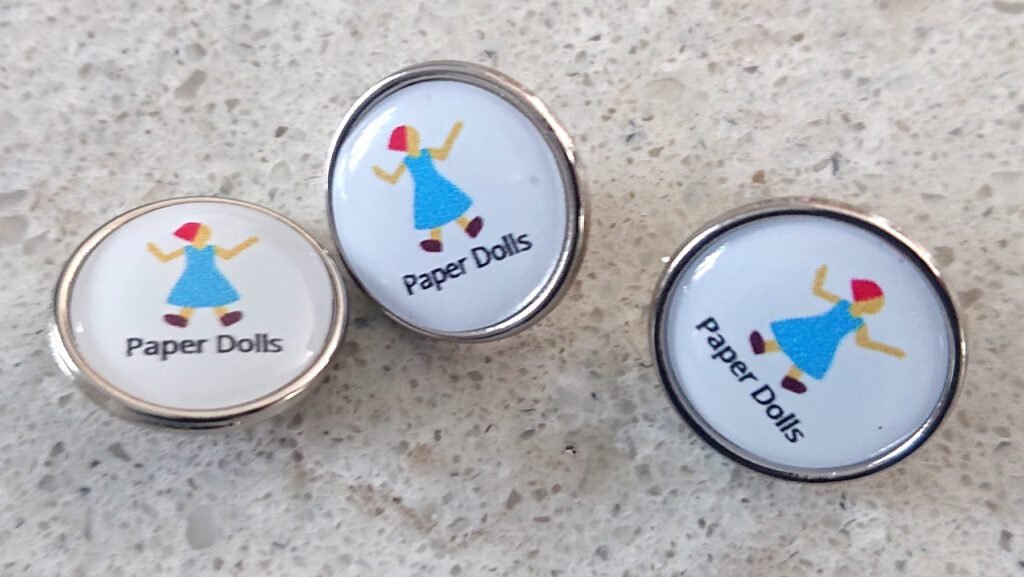 'Paper Dolls' pin badges